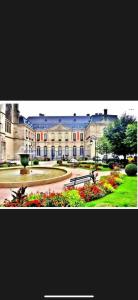a large building with flowers in front of it at Appartement chaleureux in Remiremont