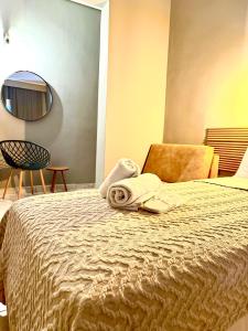 a hotel room with a bed with a towel on it at ESPERIA Drama HOTEL in Drama