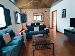 a living room with a couch and a table at Casa Rinaifi in Guatiza