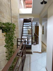 a staircase in a house with a wooden railing at Pousada Bahia Morena in Salvador +15 photos