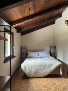a bedroom with a bed with a wooden ceiling at Malga Filippi 1241 in Polino +13 photos