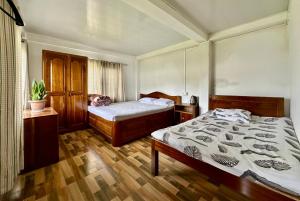 a bedroom with two beds and a window at The Tranquil Farm Stay in Thode