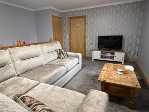 a living room with a couch and a coffee table at The Old Salt House, Flat 2 in Wick