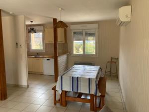 a kitchen with a table in the middle of it at Maison de vacances in Cosnac
