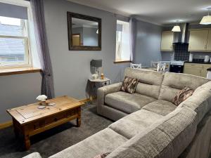 a living room with a couch and a table at The Old Salt House, Flat 2 in Wick