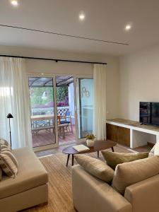 a living room with a couch and a table at Vila Antic in Almancil