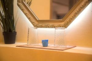a mirror on top of a table with a blue candle at Spacious vintage styled basement apartment - private in Calgary
