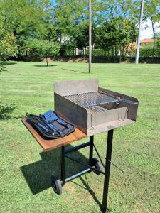 a grill sitting in the grass in a park at Appartamento Al Forte in Cavallino-Treporti