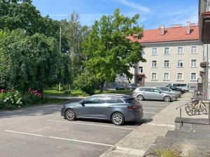 a row of cars parked in a parking lot at Akord Apartments with FREE PARKING in Pärnu