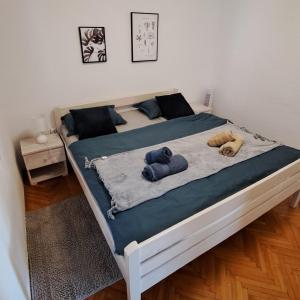 a bedroom with two beds with stuffed animals on it at Holiday home Blue 40 m from beach in Kruševo