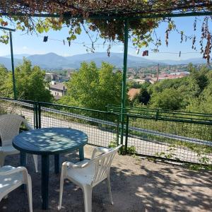 a table and chairs with a view of the mountains at Studio Relax in Travnik