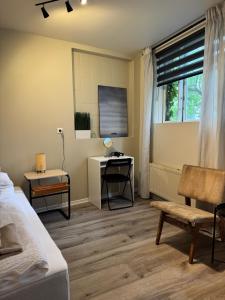 a bedroom with a bed and a desk and a window at Rock Village Apartments - Central Reykjavík Stay in Reykjavík