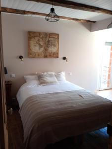 a bedroom with a large bed in a room at Gîte Le Mansois in Marcillac-Vallon
