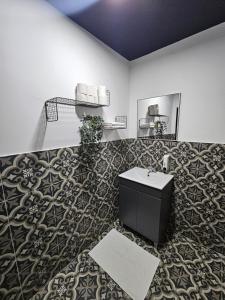 baño con lavabo y pared en Ehad Haam Urban Suite, en Haifa