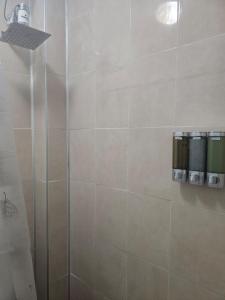 a bathroom with a shower with a glass door at The White Point in San Juan +21 photos