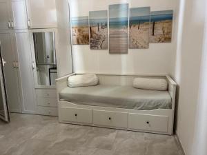 a room with a bed with paintings on the wall at CasaDiFlavio in Torvaianica