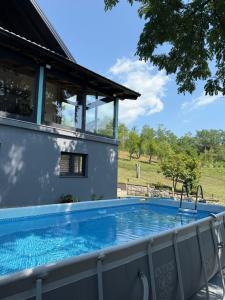 a swimming pool in the backyard of a house at Vikendica Radoš in Tutnjevac