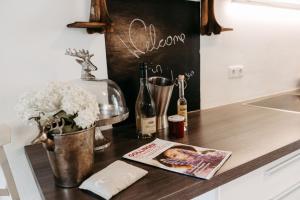 a kitchen counter with a magazine and bottles of wine at Chalet Austria, famous ski areas around us, 15 min to salzburg city, direct mountain view, up to 10 people in Golling an der Salzach
