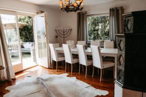 a dining room with a white table and chairs at Chalet Austria, famous ski areas around us, 15 min to salzburg city, direct mountain view, up to 10 people in Golling an der Salzach