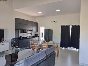 a living room with a couch and a table and chairs at Casa em condomínio porto marina in Ananindeua