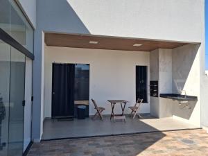 a patio with a table and chairs next to a building at Casa em condomínio porto marina in Ananindeua