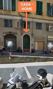 a scooter parked in front of a building with a home sign at Appartamento Esclusivo De Ferrari - Genova Centro Storico in Genova +4 photos