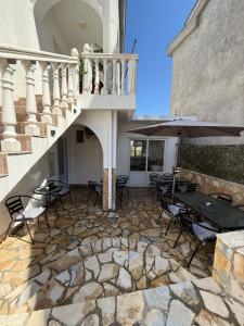 a patio with tables and umbrellas on a building at Apartments Lazo in Ulcinj