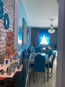 a living room with a table and a dining room at Coastal Elegance in Martil