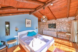 a bedroom with a bed and a stone wall at Kale Lodge - Adult Only + 15 in Kas