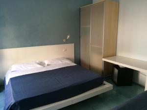 a bedroom with a bed with a blue blanket at Rock Garden in Gaeta +41 photos