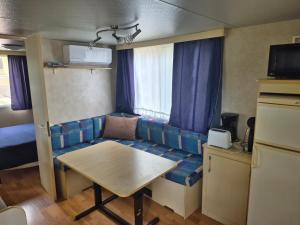 a living room with a couch and a table at Camp Sita in Vir +51 photos