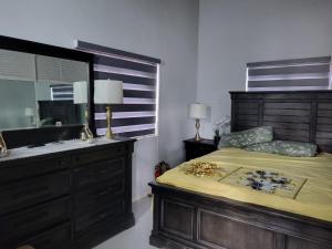 a bedroom with a bed with a sink and a mirror at 3CsMontego Bay in Montego Bay +142 photos