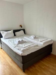 a bed in a room with white sheets on it at Ferienwohung "Möwennest mit Meerblick" Dahme in Dahme