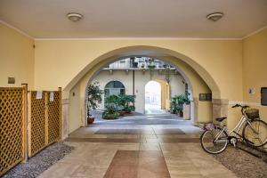 a bike parked in a hallway with an archway at BettinBlue - Rovereto in Rovereto