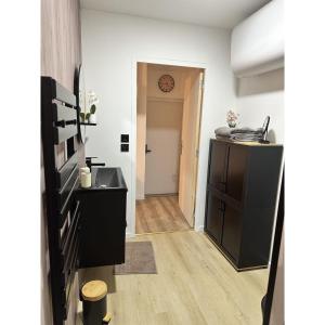 a hallway leading to a room with a clock on the wall at Suite CARLA in Vesoul