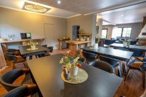 a restaurant with tables and chairs in a room at Gazdówka Cisna in Cisna