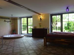 a large bathroom with a tub and a bed in it at Auszeit Posthausen in Machern
