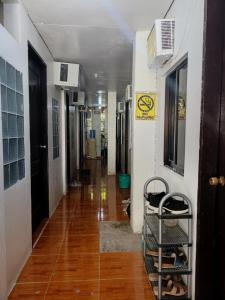a hallway of a hospital with wooden floors and a long hallway at Arlene's Homestay Siargao in General Luna