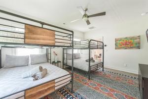 a bedroom with two bunk beds with a dog laying on the bed at 4BR Queen City Base Minutes to Stadium & NoDa in Charlotte