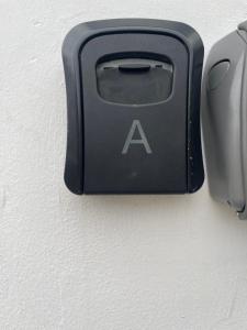 a black electrical outlet on a wall next to a mouse at Nahoon Studio A in East London