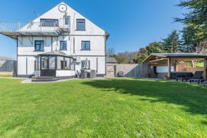 a large white house with a large yard at Pembrokeshire Near Beach With A Hot Tub in Pembroke