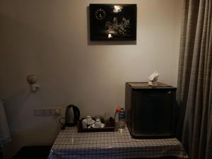 a bathroom with a toilet and a tiled floor at 4s Heaven in Ella
