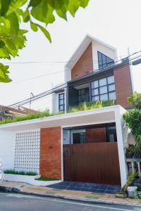 a house with a wooden gate in front of it at Griya Saka Magelang in Magelang