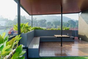 a bench sitting on top of a balcony at Griya Saka Magelang in Magelang