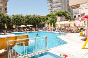 a large swimming pool with people in a hotel at Sunway Apart Hotel in Alanya