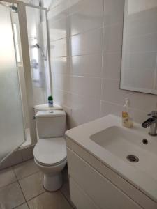 a white bathroom with a toilet and a sink at Appartement La Casa Verde in Llança