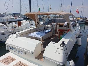 a white boat is docked in the water at Boat4u 2 in Cavallino-Treporti