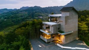 an aerial view of a house in the mountains at Secret Cliff Villa-Chinese-Free Pick Up Service, A free nutritious light meal, Free Afternoon Tea, Designer Hotel,Aesthetics Culture Experience, Bamboo forest,Healing& Secret Realm in Zhangjiajie