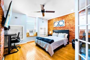 a bedroom with a bed and a brick wall at Federal Hill & Inner Harbor Lux Retreat Sleeps 6 in Baltimore