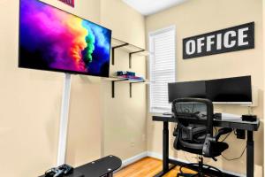 a office with a desk with a monitor and a chair at Federal Hill & Inner Harbor Lux Retreat Sleeps 6 in Baltimore